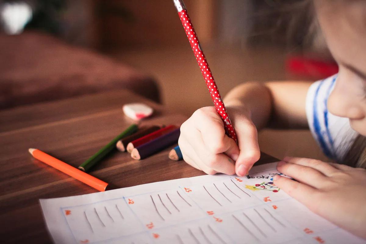 A child colouring with pencils